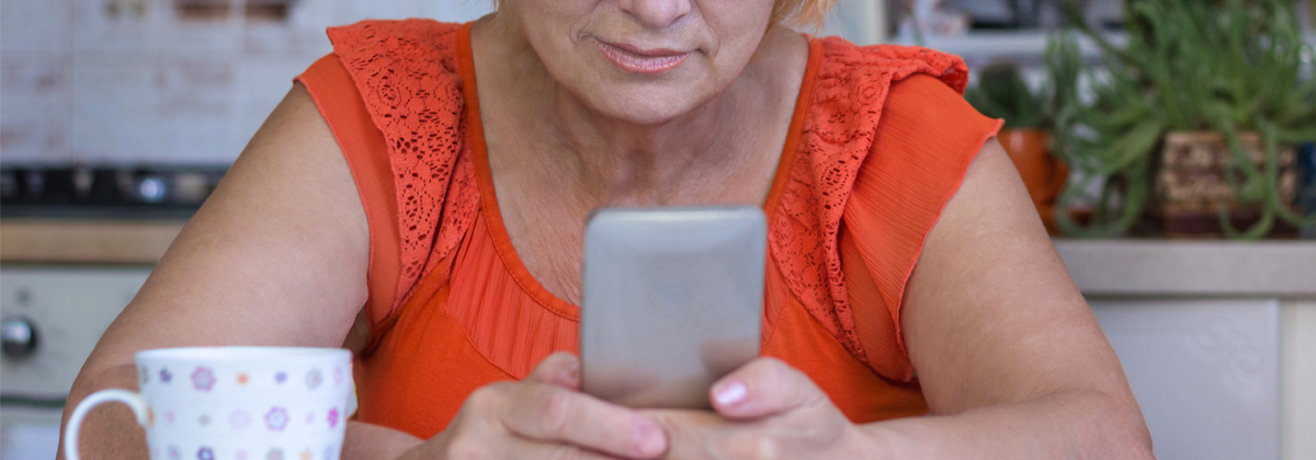 Kvinna tittar på sin mobiltelefon.