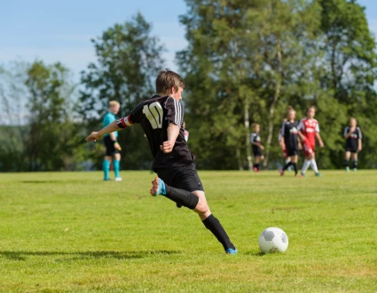 En pojke spelar fotboll