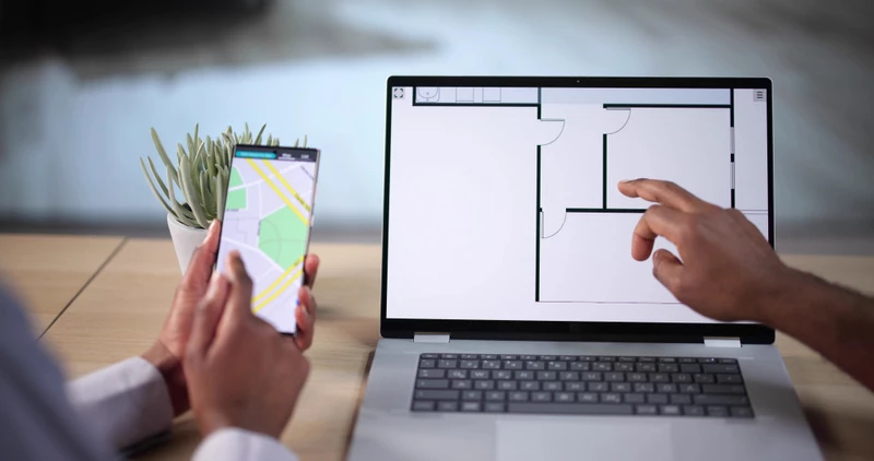 Ritning på dator samt karta på en mobil